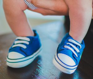 niebieskie buciki niemowlęce założone na stópki dziecka